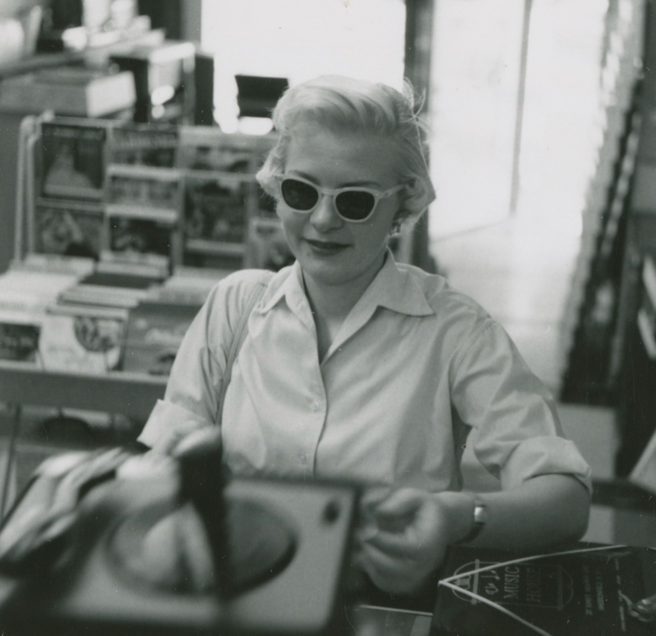 Woman browsing records in the 1950s